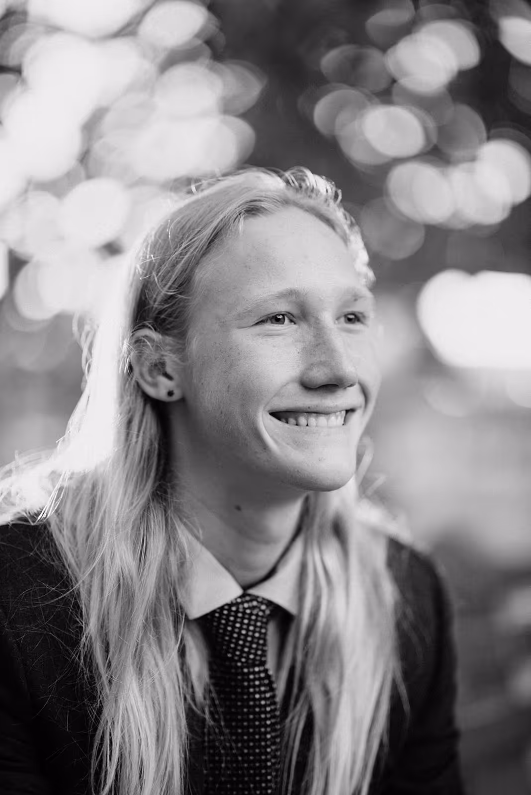 a person with long blonde hair smiling