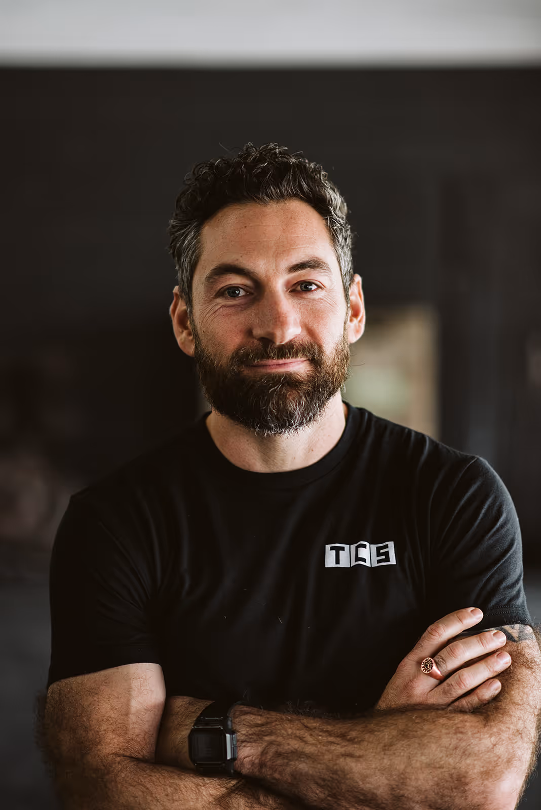 a man with a beard and mustache wearing a black shirt