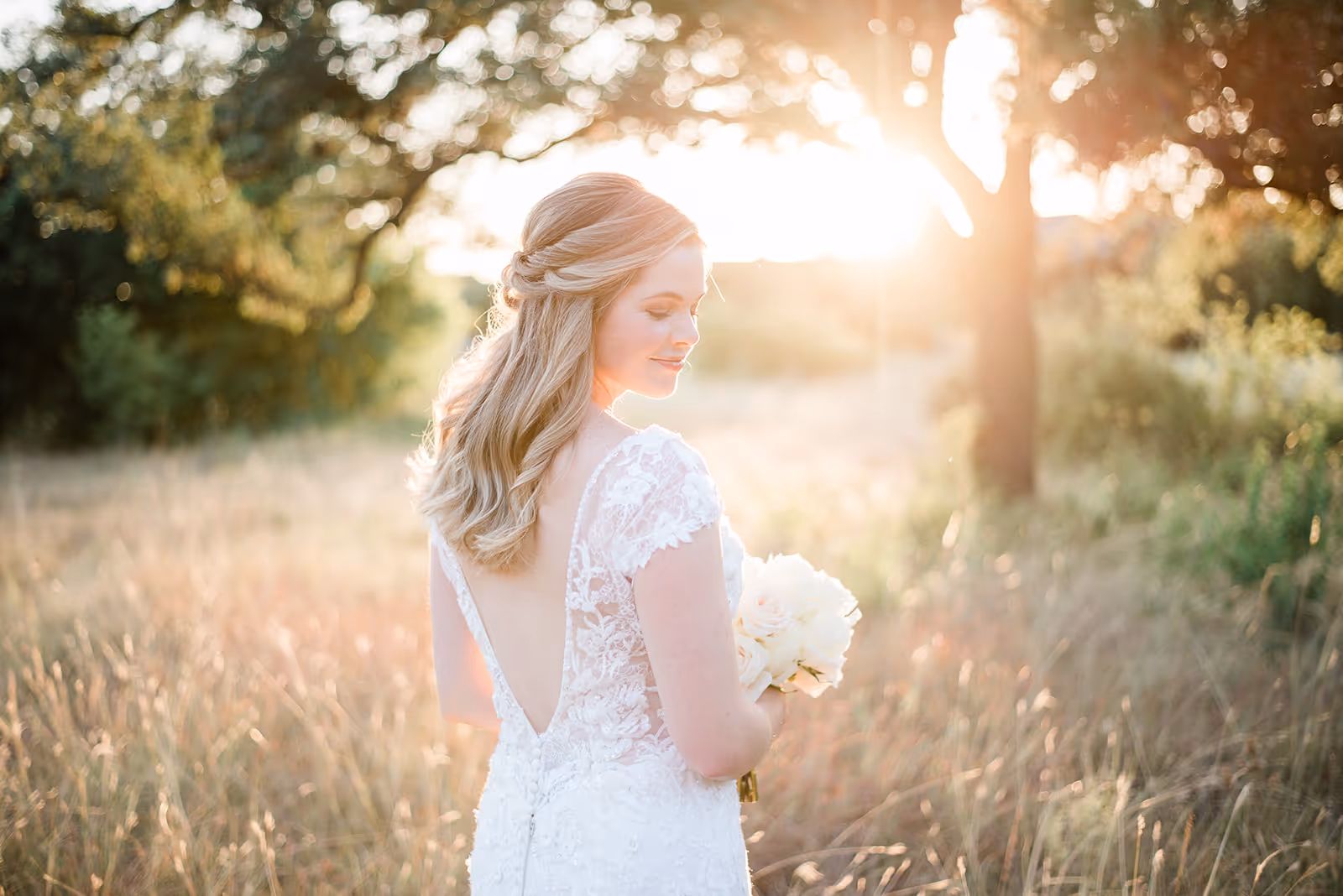 a woman in a white dress holding a bouquet of flowers