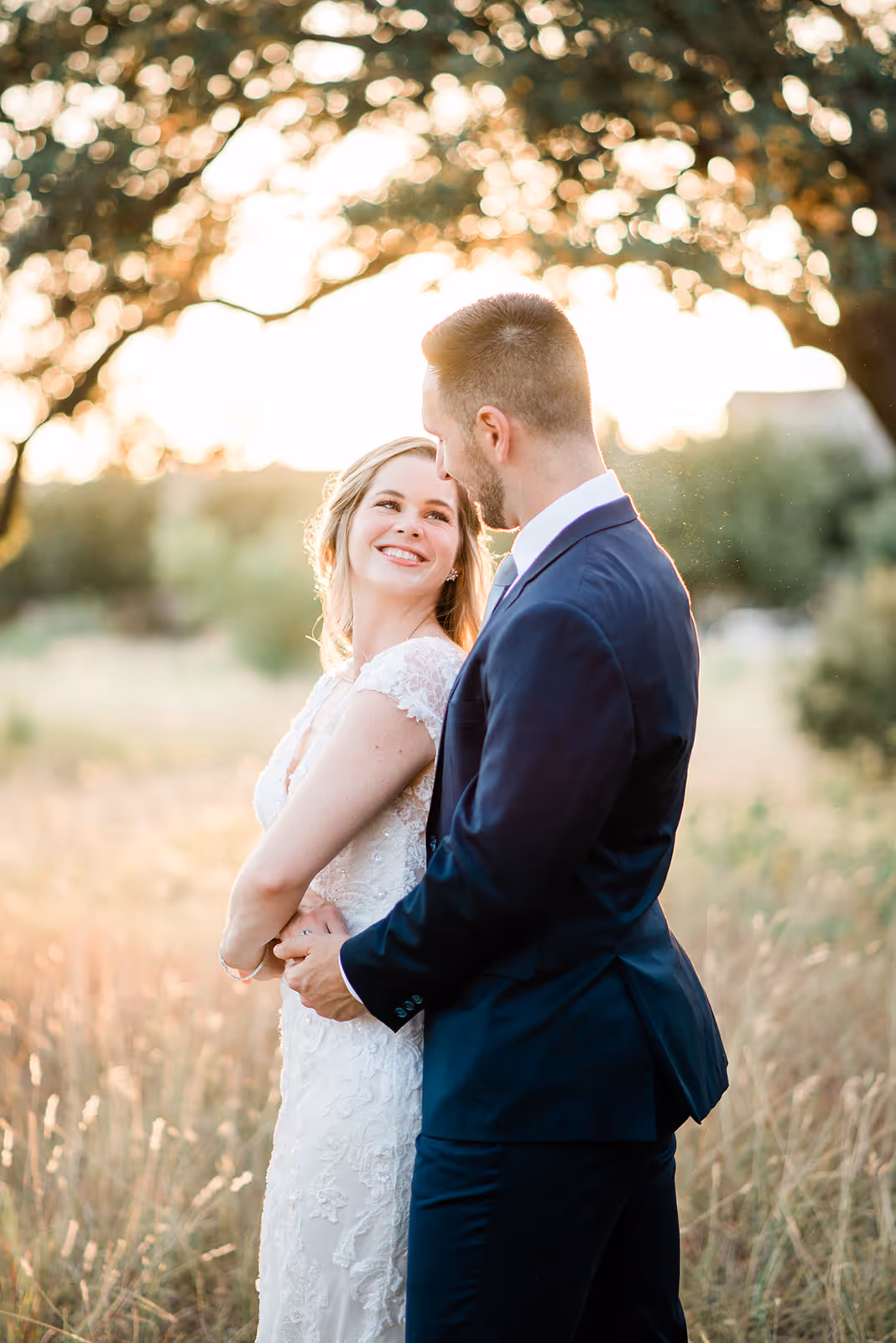 a man and woman standing in a field