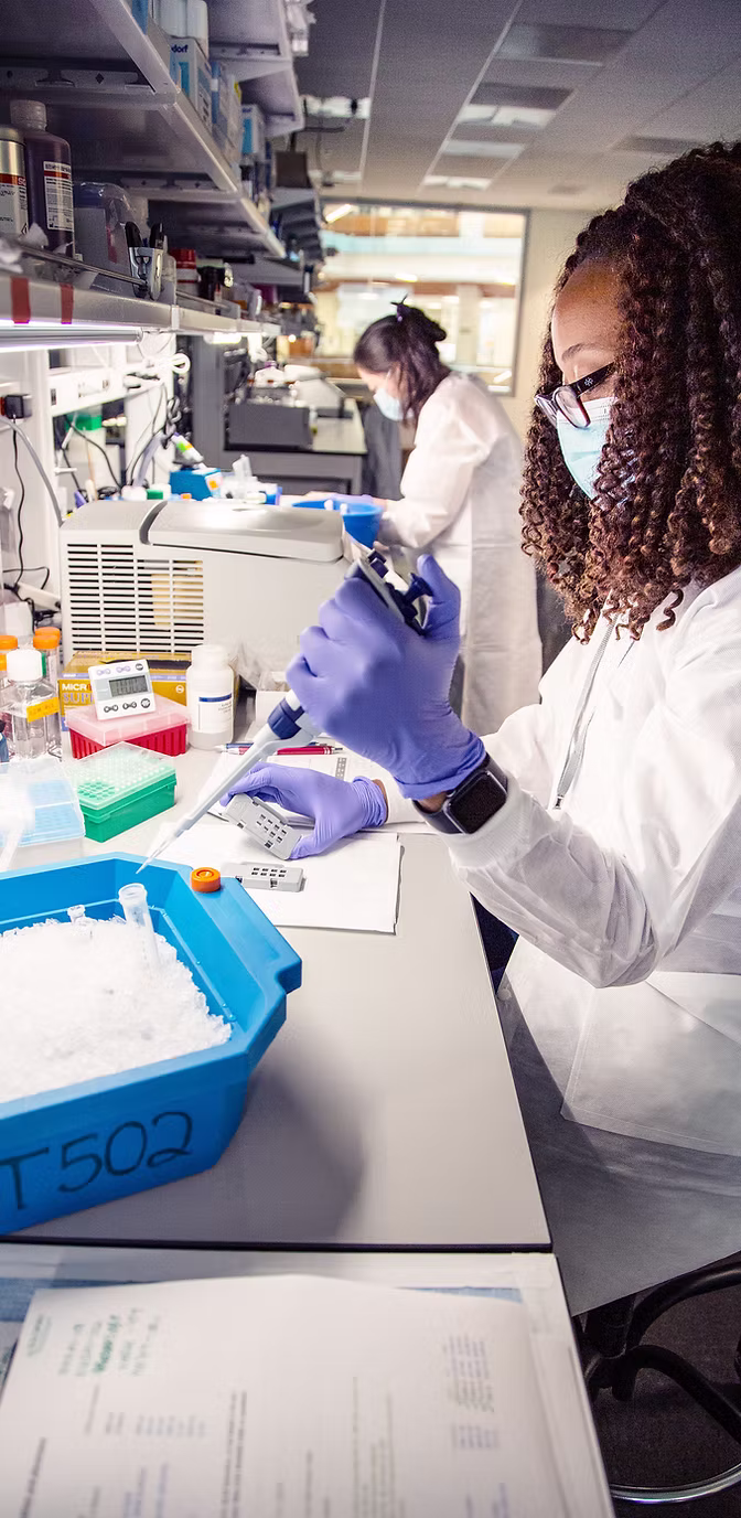 Researcher in lab coat working in laboratory.