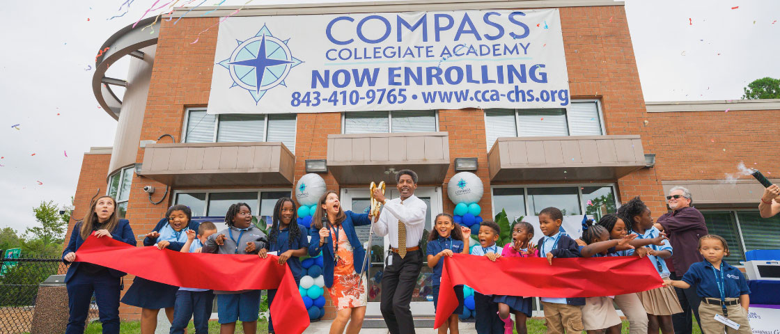 Ribbon-cutting at Compass Collegiate Academy’s new academic building, with students, staff, and community celebrating.