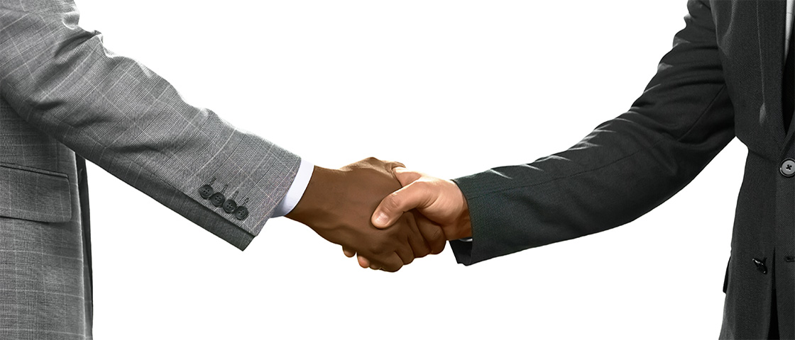 Two people in business suits shaking hands, symbolizing partnership and allyship.