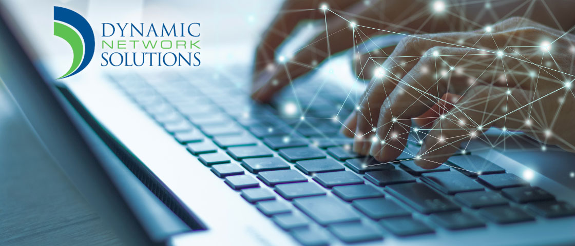 Person typing on a laptop with geometric patterns and the Dynamic Network Solutions logo overlayed, representing tech services for charter schools.