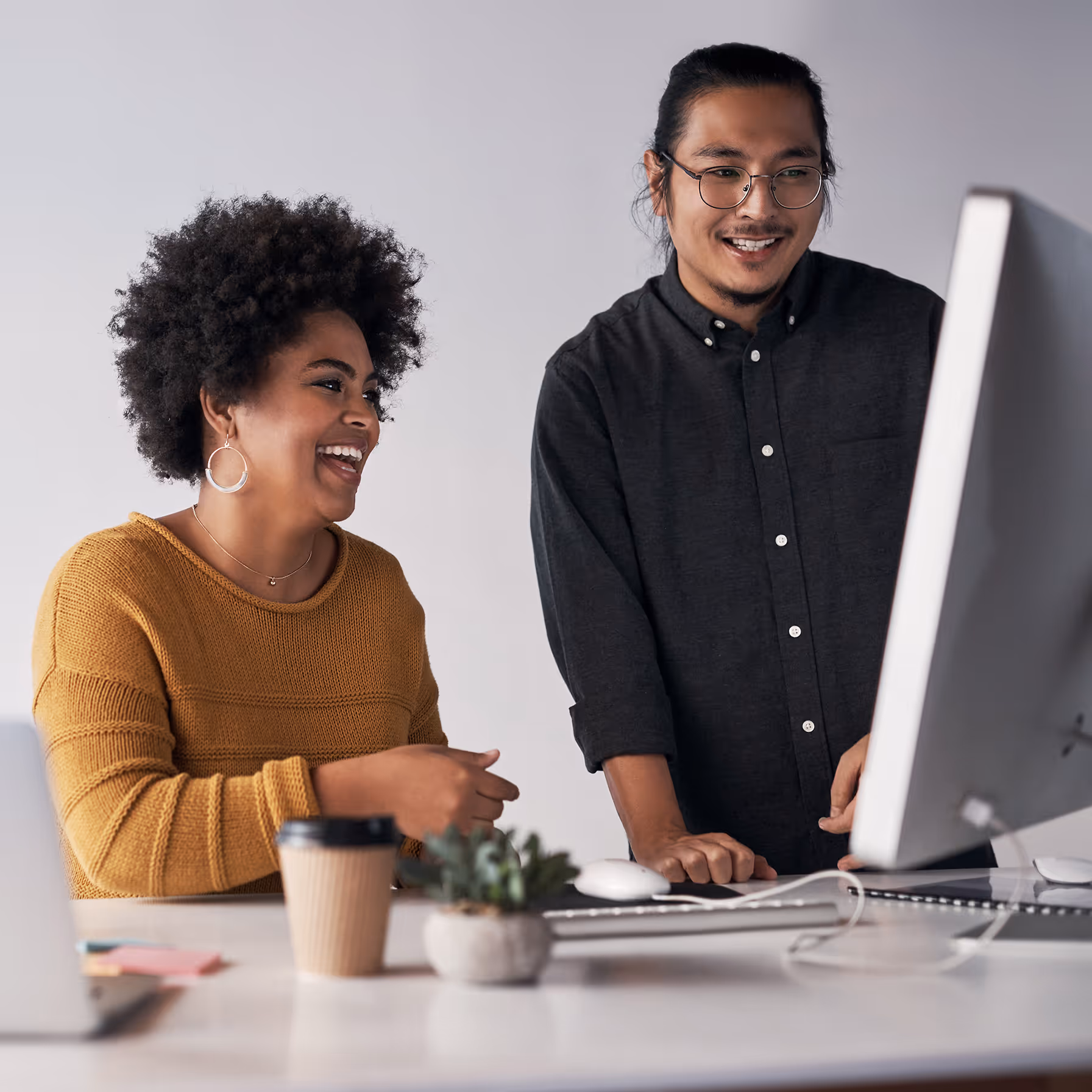 Two internal communicators building an email using a Broadcast template.