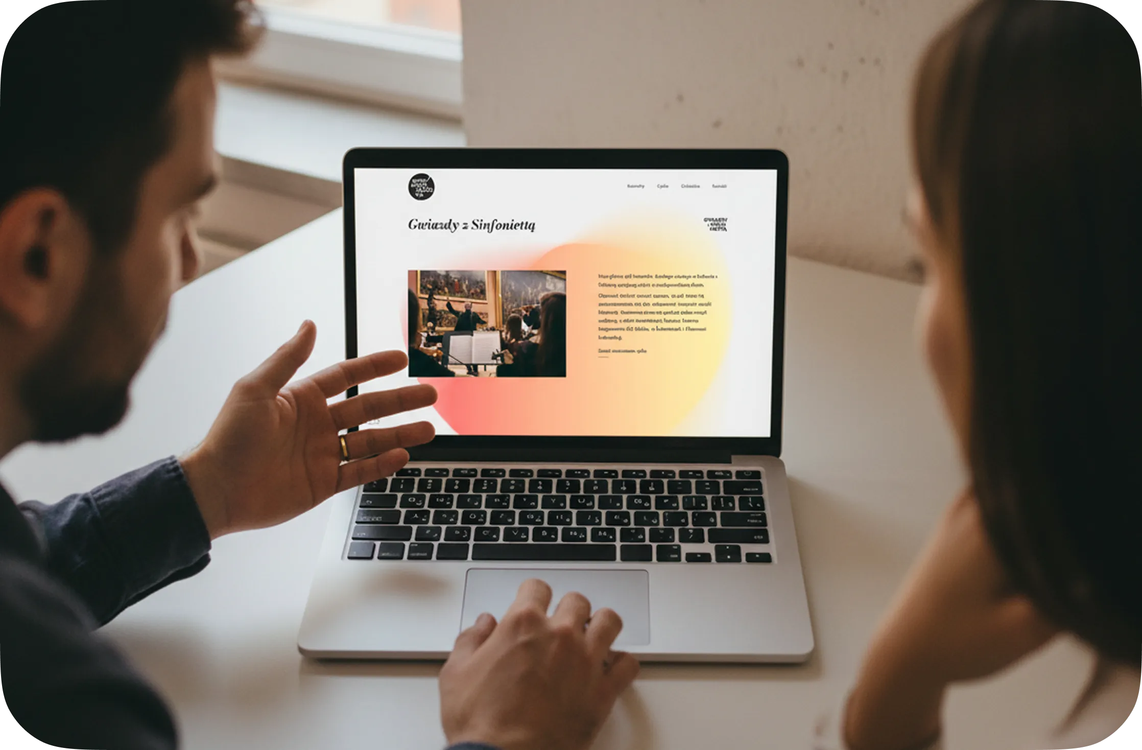 follow.studio design support offer. Two people view a laptop screen showing a website discussing the design.