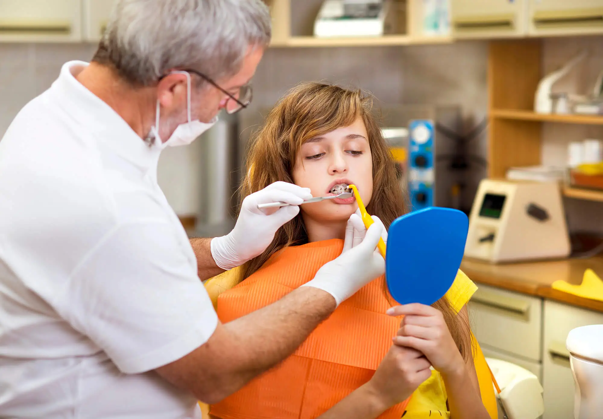 Dentist Explaining How to Keep Your Braces in Farmington Clean
