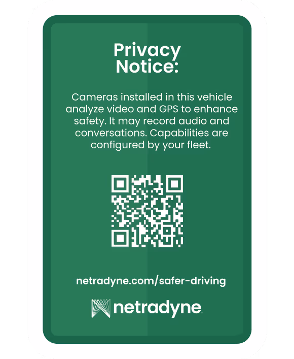 Green privacy notice sign stating that cameras in the vehicle analyze video and GPS to enhance safety and may record audio and conversations, with a QR code and netradyne.com/safer-driving link.