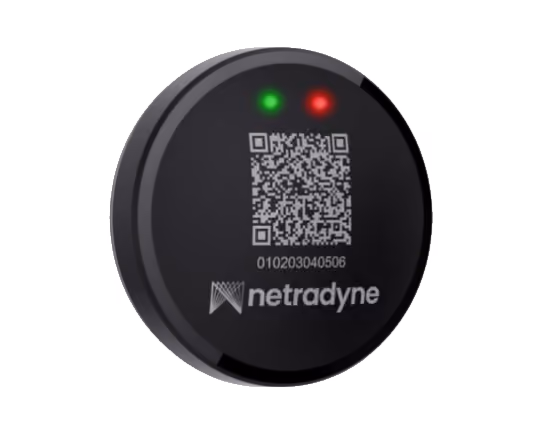 Black circular Netradyne device with a QR code, a numeric code, and red and green indicator lights.