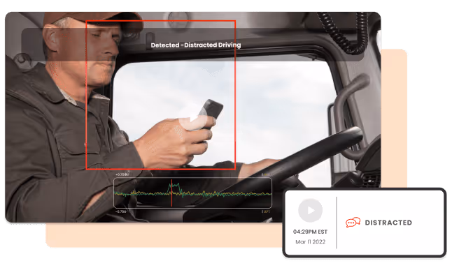 A distracted man inside a truck cab looking at his phone while driving