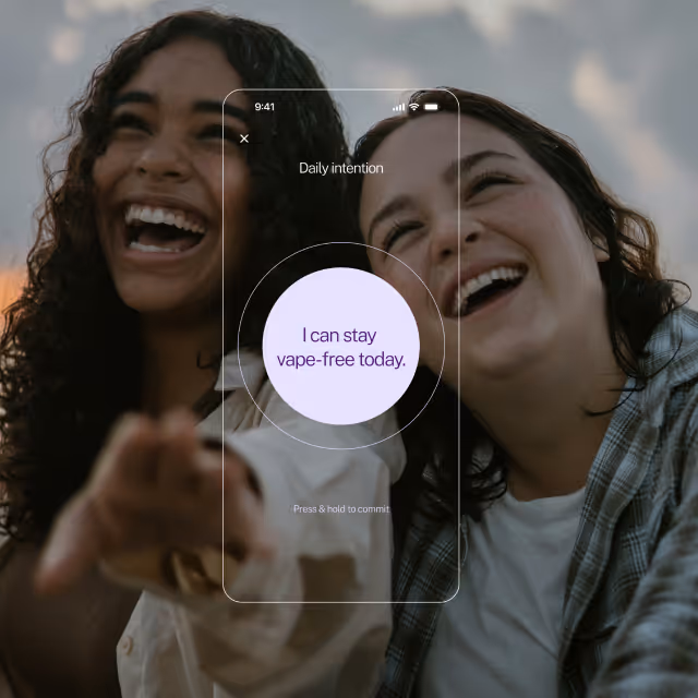 Two young women smiling and laughing outdoors with a smartphone screen overlay showing a daily intention message: 'I can stay vape-free today.'