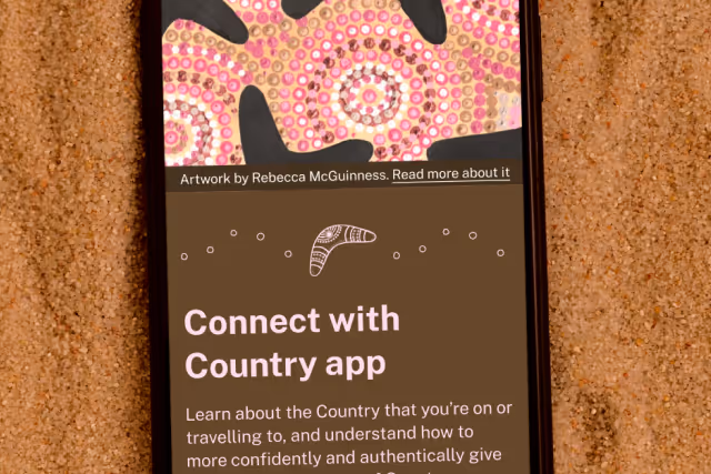 Smartphone screen showing the Connect with Country app with Aboriginal dot art and text about learning and understanding Country.