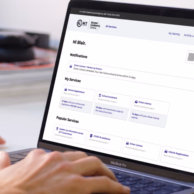 Close-up of a laptop screen displaying a personalized online government services portal welcoming user Blair with notifications and service options.