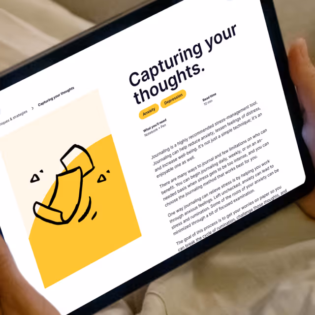 Tablet screen showing an article titled 'Capturing your thoughts.' about journaling to relieve anxiety and depression with a yellow paper icon illustration.
