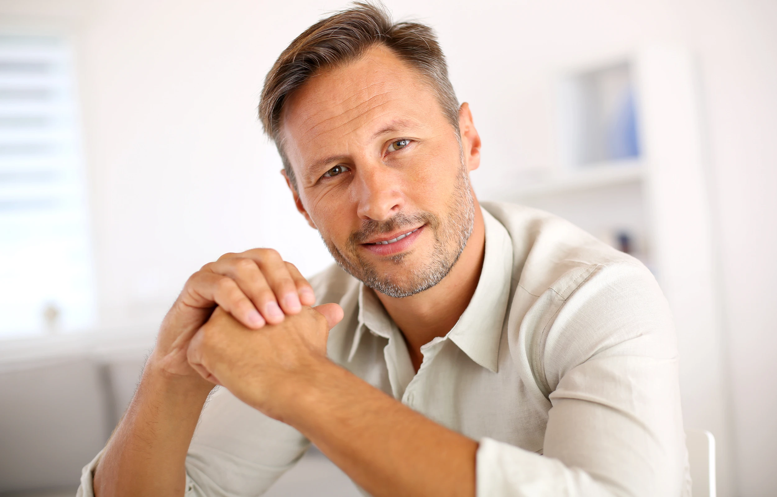 A man smiling with nice hair