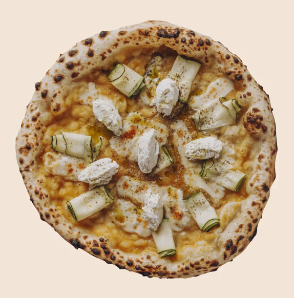 Neapolitan-style pizza topped with rolled zucchini slices and dollops of ricotta cheese on a creamy sauce base.