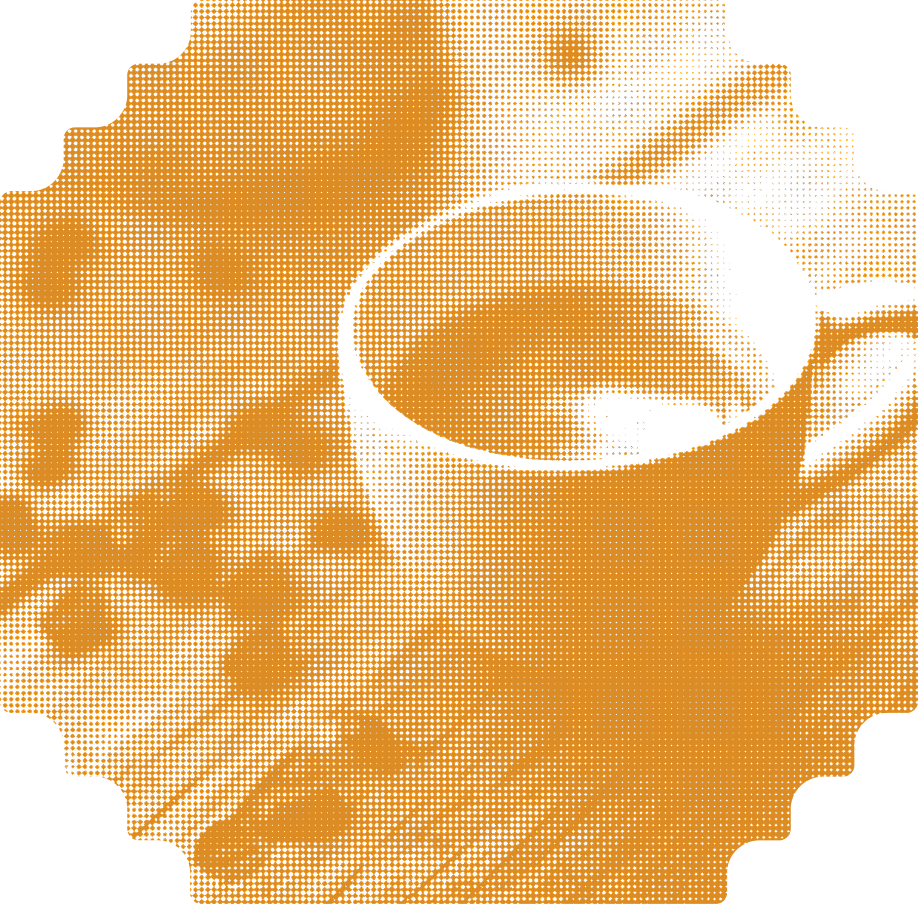 Close-up of a coffee cup with frothy espresso on a table with a spoon.