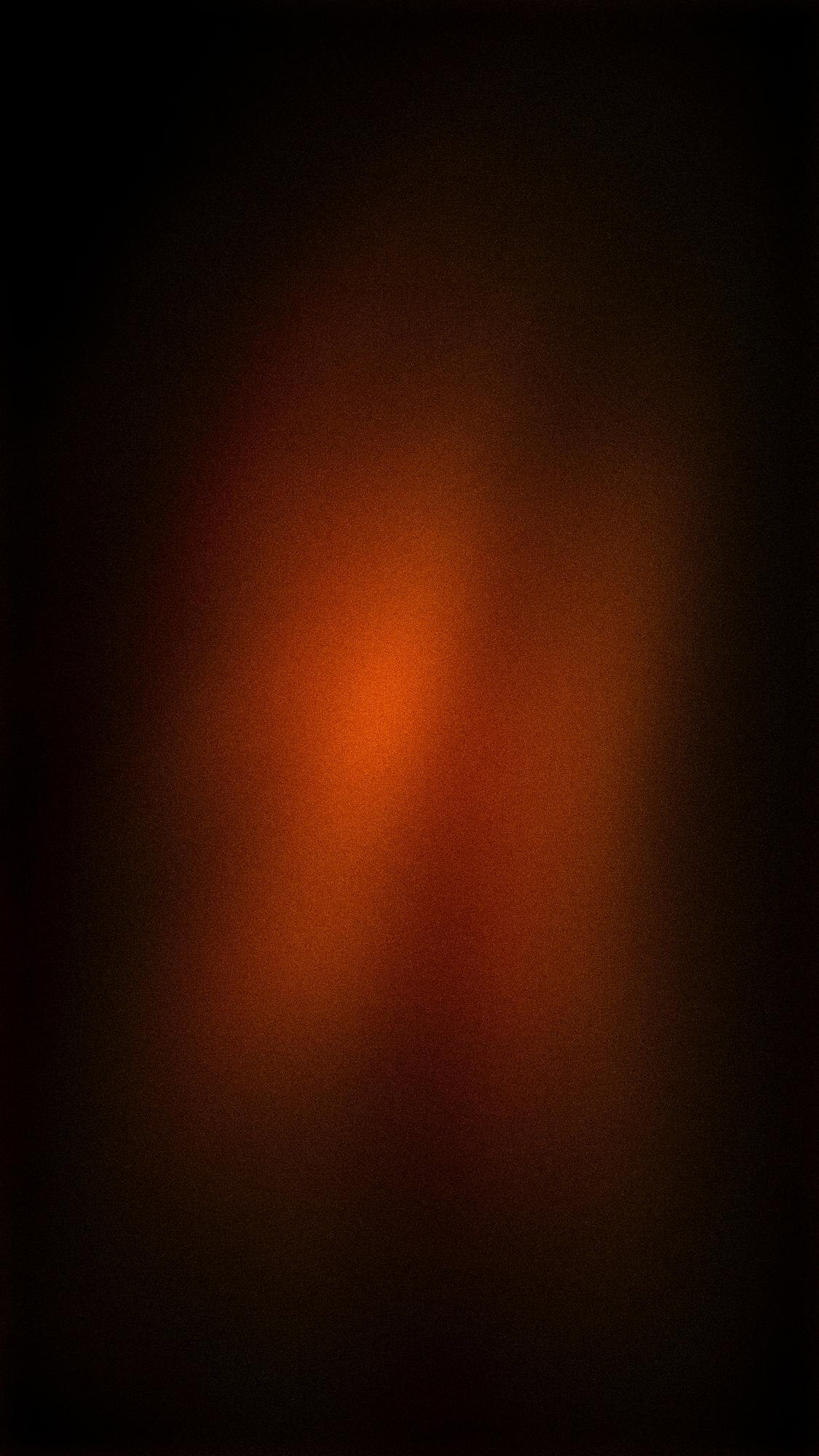 Sumuinen, oranssi ja tummanruskea tausta, jossa on rakeinen rakenne ja epätasainen valaistus.