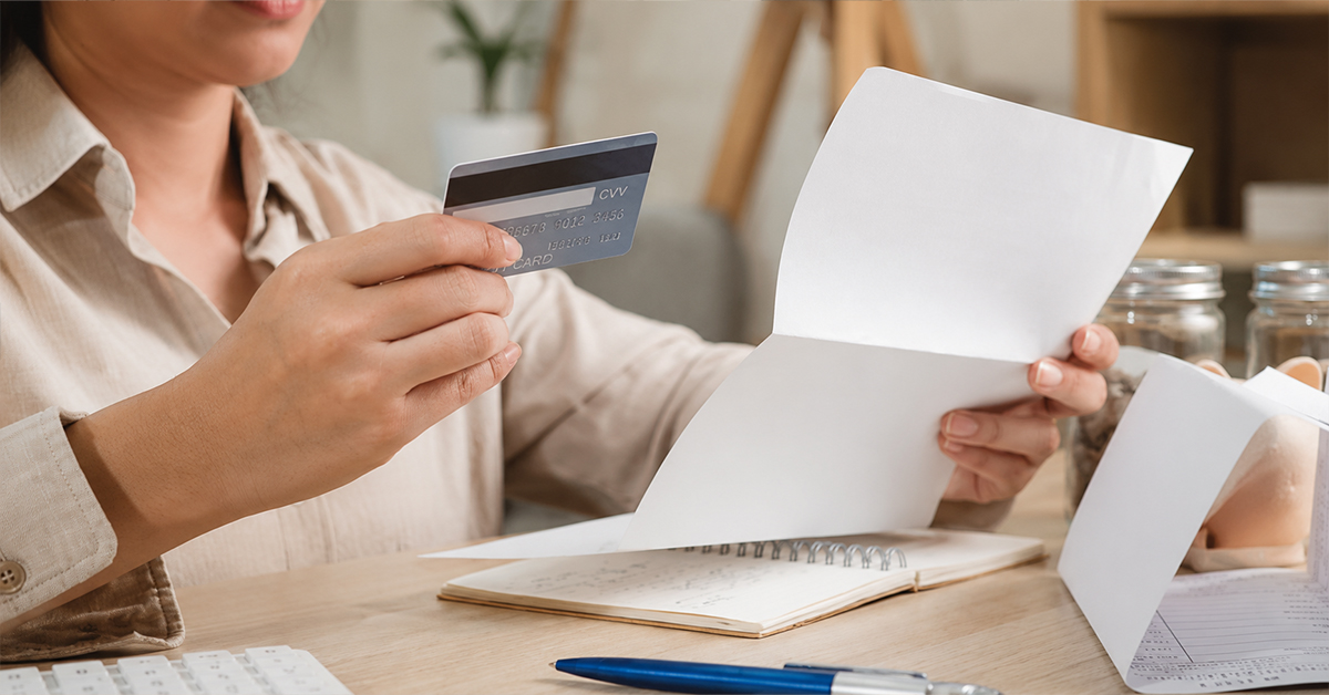 Woman reviewing bills and payment options while planning for IVF treatment costs