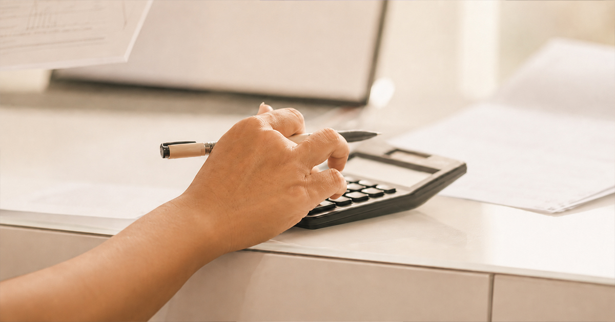 Person calculating medical expenses while planning an IVF treatment budget