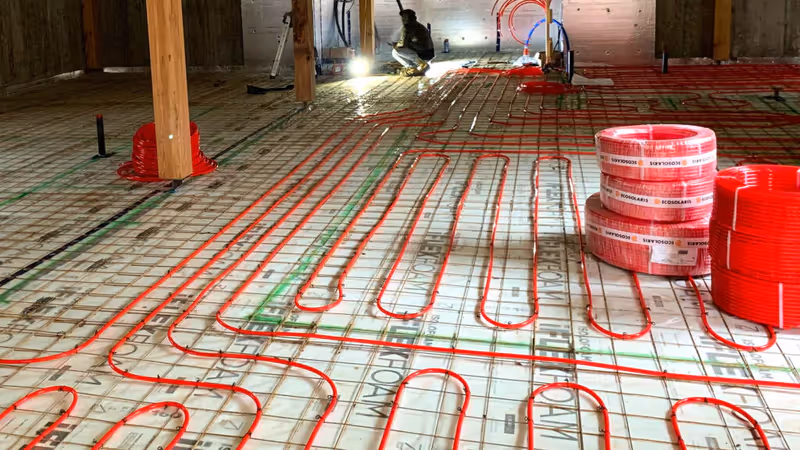 Red radiant heating pipes on styrofoam insulation