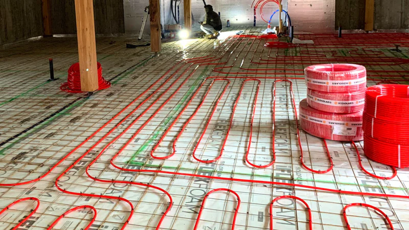 Red radiant heating pipes on styrofoam insulation