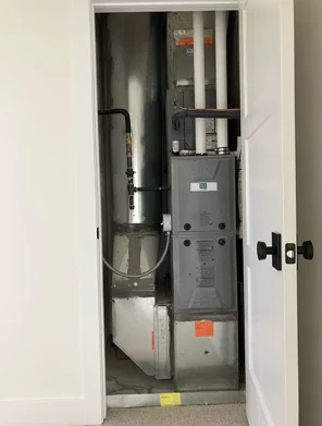 Heater unit inside a closet in a home, showcasing the essential components for heating, relevant to heater repair services in Duchesne, UT.