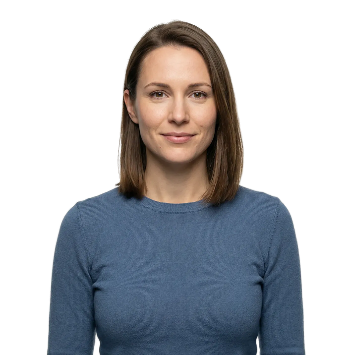 Smiling woman with shoulder-length brown hair wearing a blue sweater.