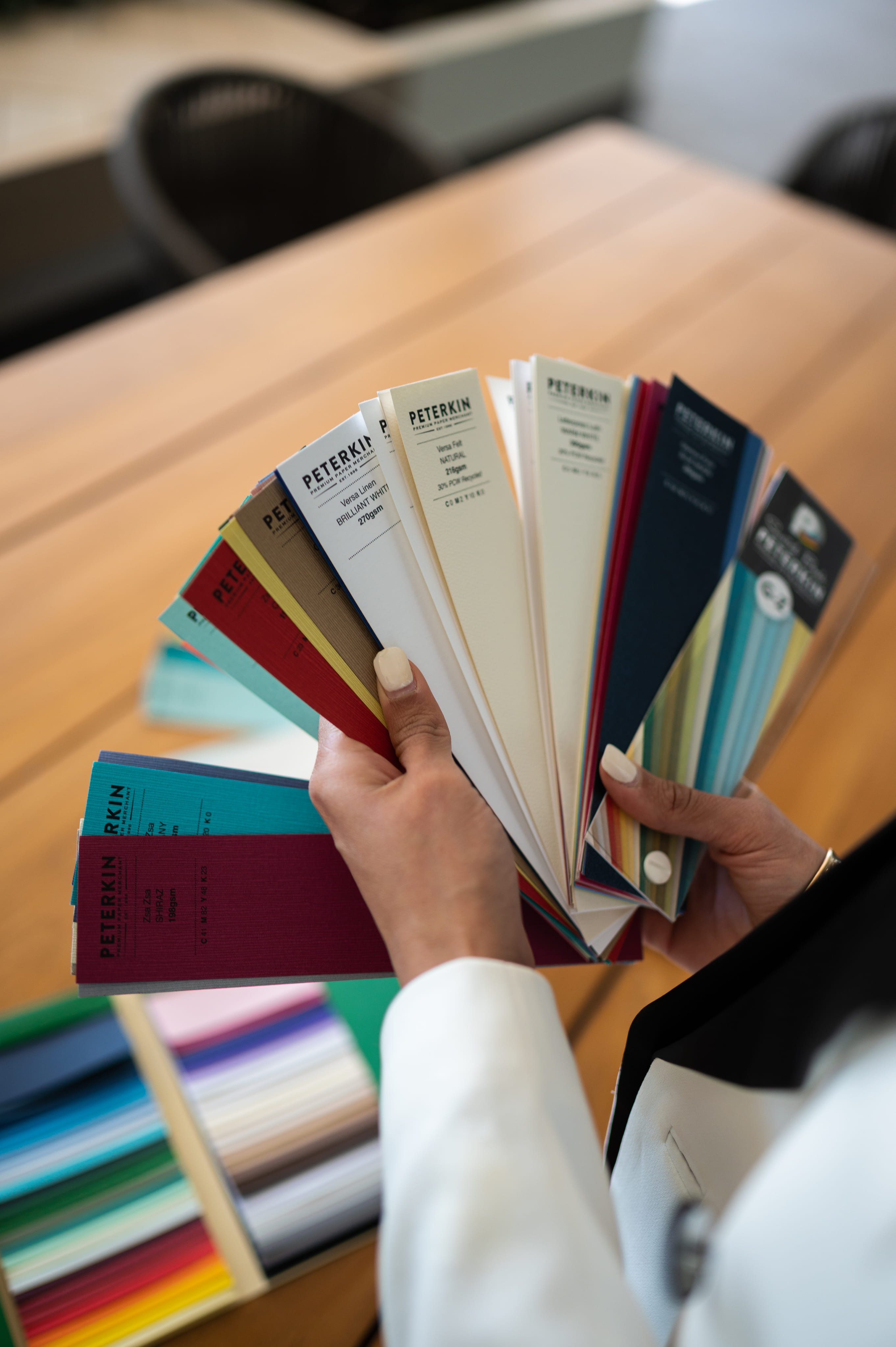 A hand holding a spread stack of cards