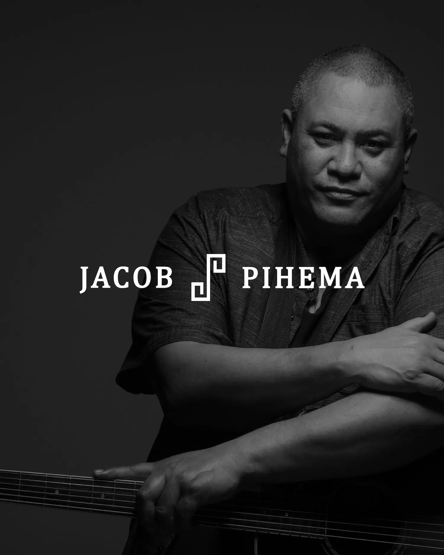 a person posing holding a guitar neck with black and white effect