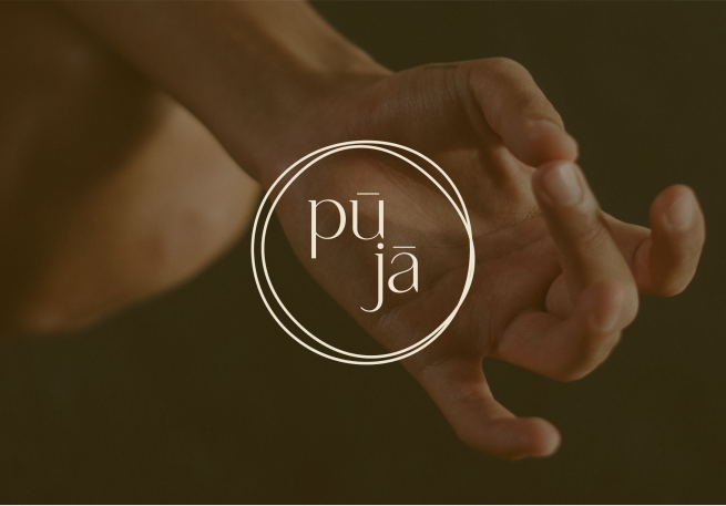 a hand with a thumb and a middle finger meet like doing a meditation pose with puja logo in front of it