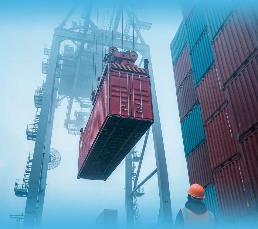 Intermodal container being lifted by a port crane during drayage operations