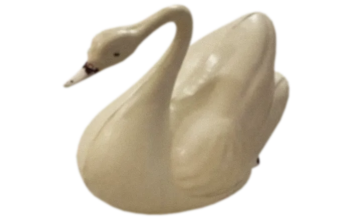 White ceramic swan figurine with detailed wings and curved neck.
