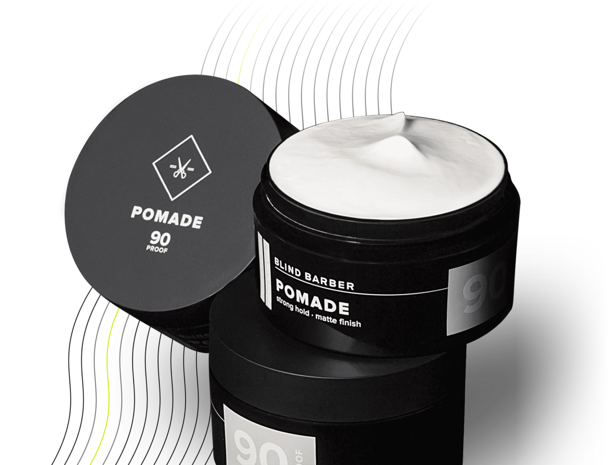 Open jar of Blind Barber Pomade with white cream inside and matching lid beside it on a black surface.