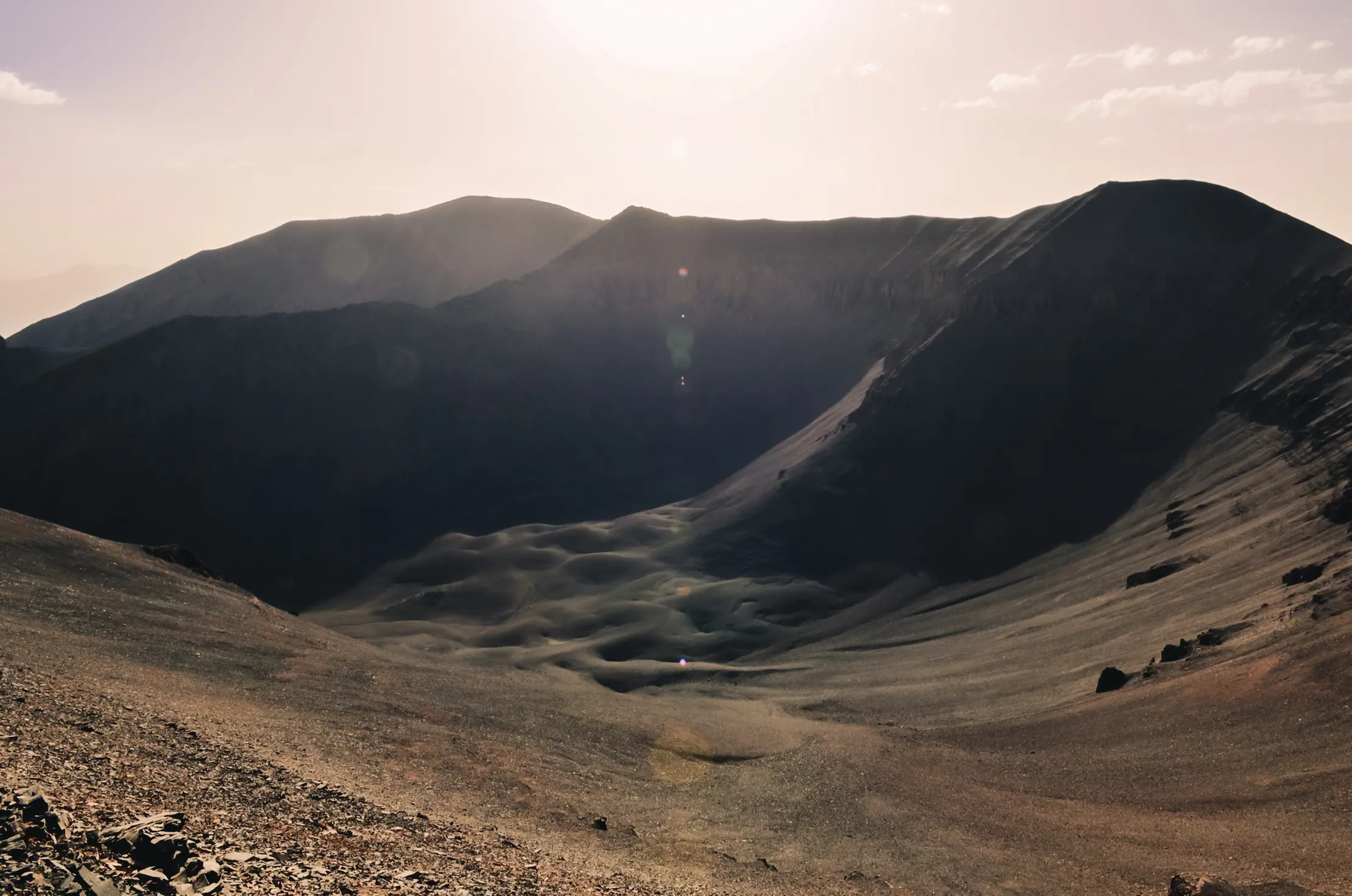 Panoramic view of a dramatic volcanic-style crater and dark ridge at high elevation in Mount M'Goun near Touda Ecolodge.