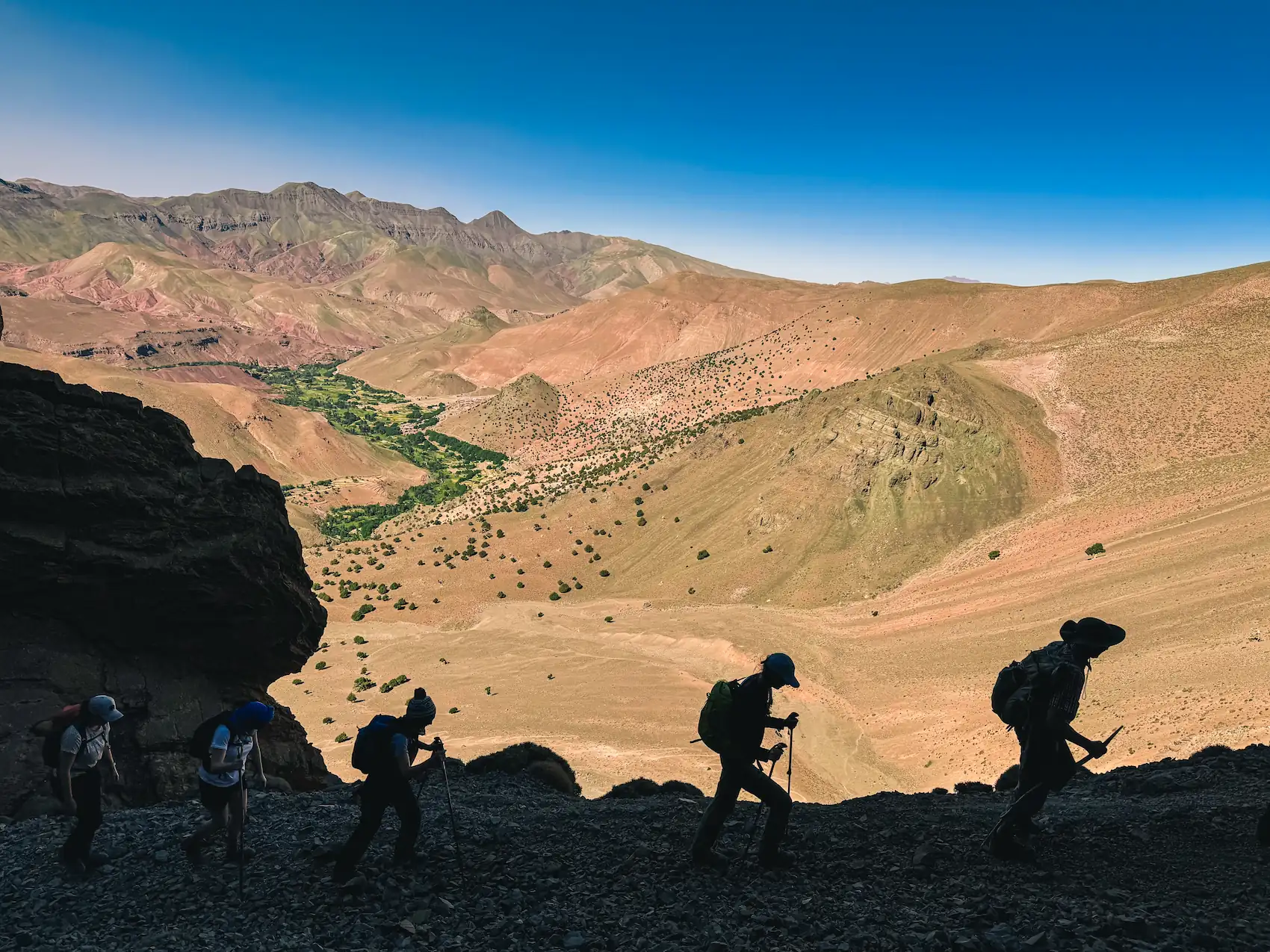 Group of hikers on a High Atlas trail overlooking the Aït Bouguemez Valley