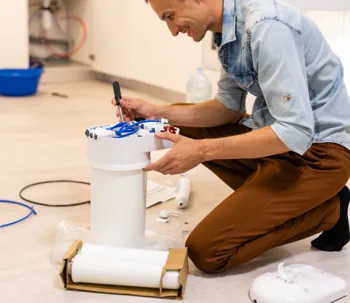 Plumber working on water filter