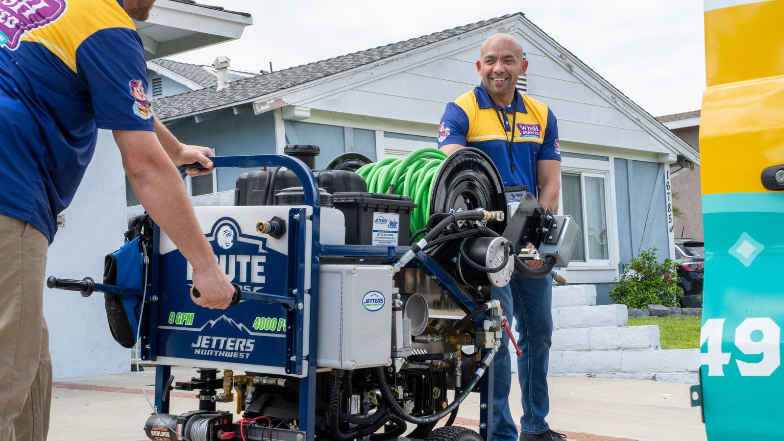 Wish Granted Plumbing team with sewer jetting equipment at a home.