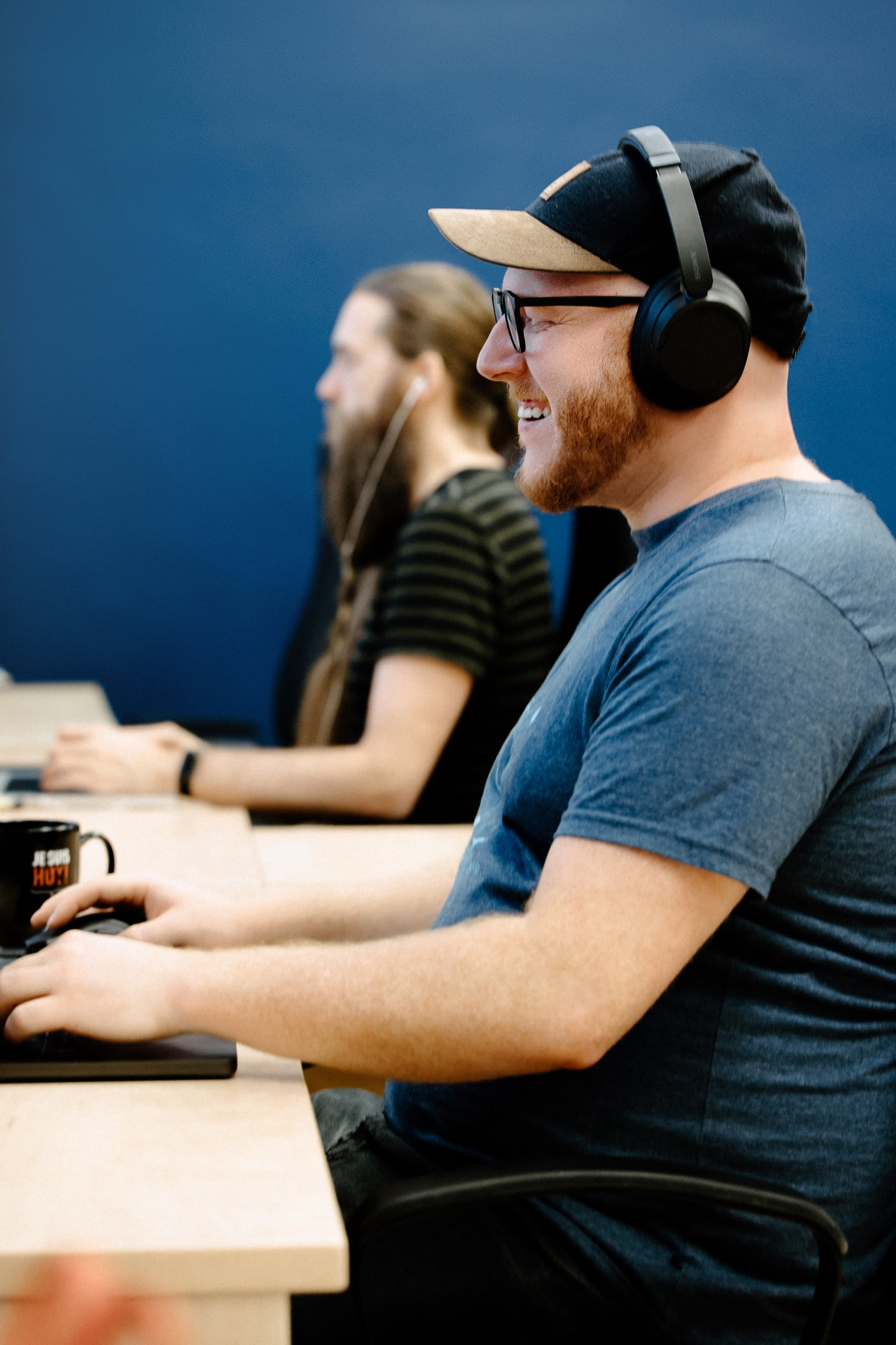 Two developers coding on the computer and smiling