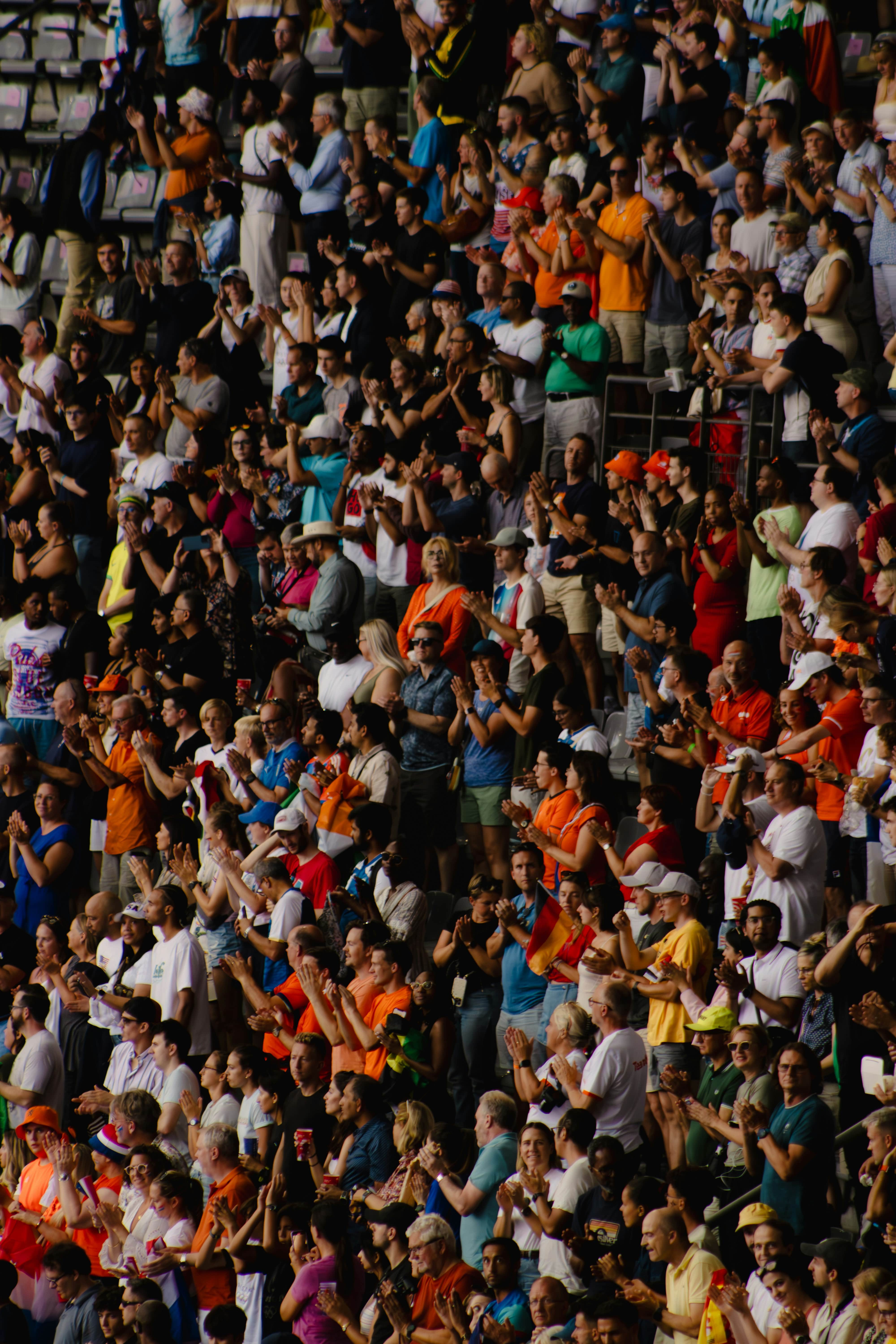 image of a Cuban athlete celebrating while holding up the Cuban flag behind them.