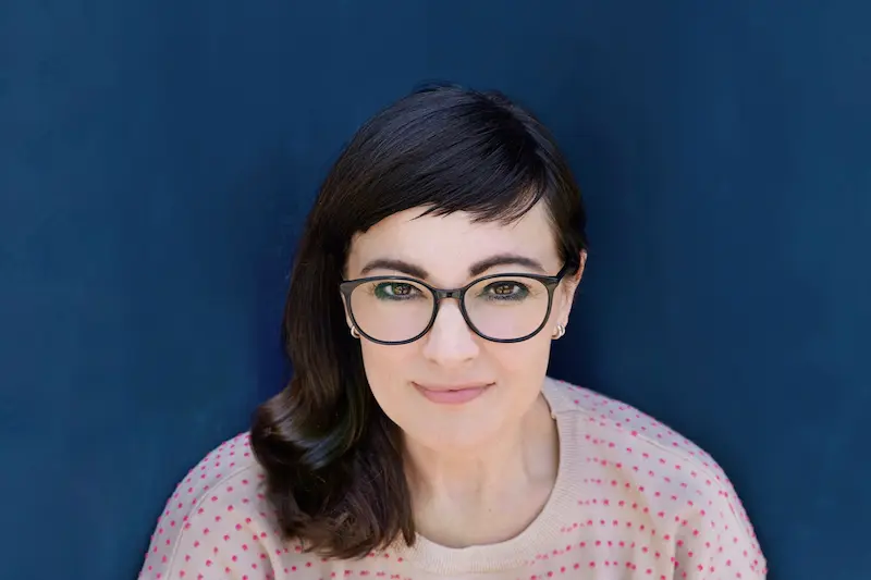  Frau mit Brille und dunkelbraunem schulterlangem Haar