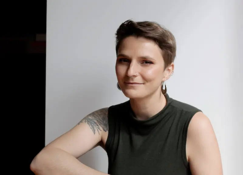 portrait of the artist wearing black t-shirt, white background