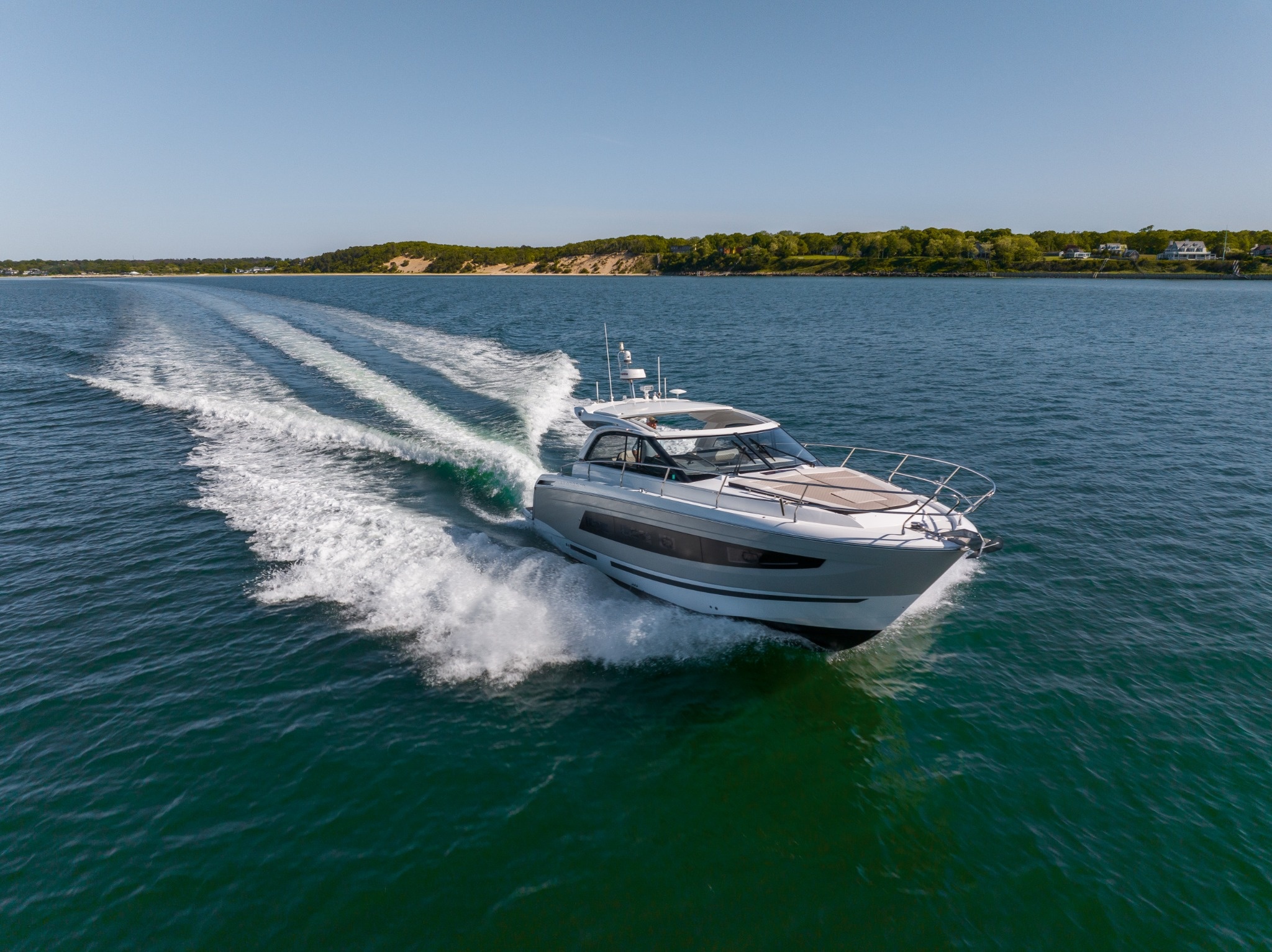 Private yacht anchored near Hamptons shoreline during a day charter