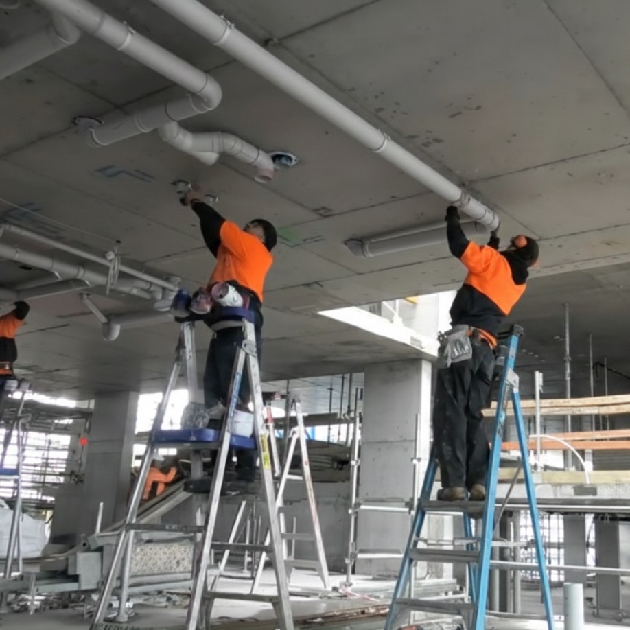 Outright plumbing team installing pipes.