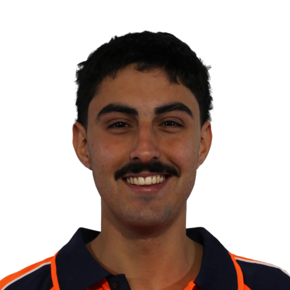 Smiling man with dark hair and mustache wearing a navy and orange collared shirt.