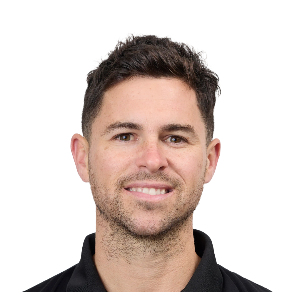 Smiling man with short dark hair and light stubble wearing a black collared shirt.