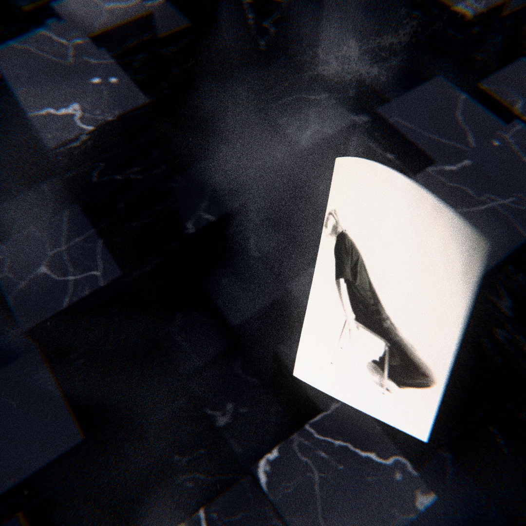 Black and white photo of a person in a long black coat sitting on a chair, overlaid on dark marble-like patterned blocks.