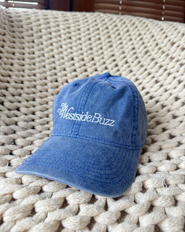 Washed denim blue cap with The Westside Buzz script embroidered in white
