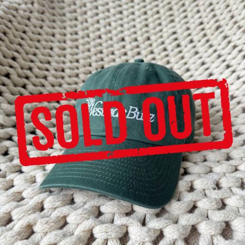 Dark green garment-washed cotton cap with The Westside Buzz script embroidered in white