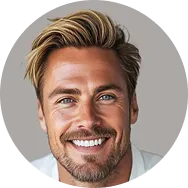 Smiling man with blonde hair and blue eyes against a neutral background.